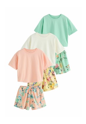Three short-sleeve tops in pastel green, cream, and peach paired with floral print shorts in matching colors.