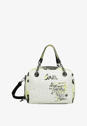 Sac à main blanc avec motifs abstraits noirs et jaunes, double anses, bandoulière amovible et finition brillante avec détails du logo.