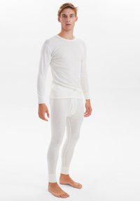 Weißes Langarm-Thermoshirt und passende Leggings aus leichtem, dehnbarem Material, mit enger abschließenden Bündchen und nahtlosem Design.
