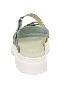 Zelené semišové sandály s bílou gumovou podrážkou. Mají nastavitelný popruh a polstrovanou stélku, navržené pro pohodlí a podporu.