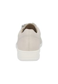 Beige sneaker with a smooth texture, featuring a low heel, rounded shape, and a silver zipper accent on the back. White sole.