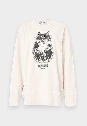 Λευκό φούτερ Moschino με απεικόνιση μαύρης και άσπρης γάτας που φορά γυαλιά και φιόγκο, με το κείμενο "Moschino Jeans" από κάτω.