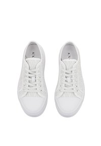 Sneakers bianche con tomaia testurizzata a motivi geometrici, lacci piatti e punta in gomma liscia. Suola semplice con battistrada per una buona aderenza.