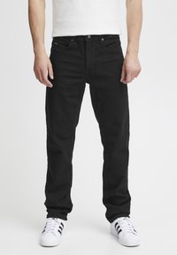 Black denim jeans with a straight fit, featuring a classic five-pocket design and subtle stitching. Worn with white sneakers.