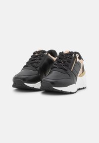 Baskets en cuir noir avec semelles blanches, agrémentées d'accents roses, d'une fermeture éclair décorative et de lacets texturés. Bout arrondi et design rembourré.