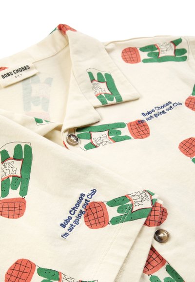 Chemise crème avec imprimé cactus vert et orange, texte brodé « Bobo Choses I'm not going out Club » et fermeture par boutons.