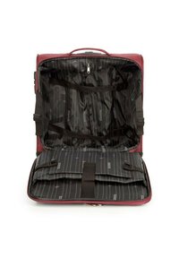 Intérieur d'un sac en tissu rouge avec une doublure à rayures noires, comportant des compartiments et des sangles ajustables. Fermeture éclair et détails en matériel durable.