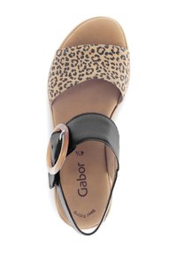 Black and leopard print sandal with a wide strap, circular buckle detail, and cushioned footbed. Lightweight construction and open silhouette.