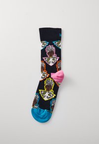 Multicolored socks with black base, featuring cartoon characters in bright outlines, pink heel, and blue toe. Made from soft fabric.