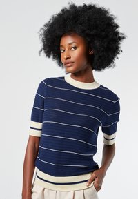 Navy short-sleeve sweater with white horizontal stripes, ribbed collar and cuffs, textured knit design, fitted silhouette.