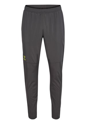 Graue Sporthosen mit elastischem Bund, schmal zulaufendem Schnitt und einem kleinen grünen Logo am linken Oberschenkel. Hergestellt aus leichtem, flexiblem Material.