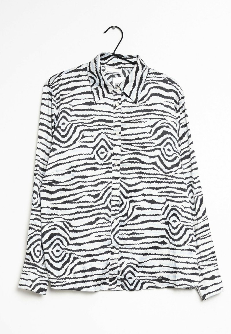 Long-sleeve, button-up shirt made of soft fabric featuring a black and white wavy striped pattern, with a pointed collar and side pockets.
