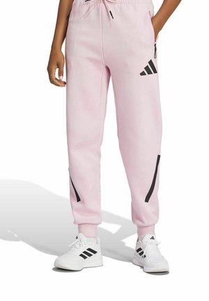 Svijetlo ružičaste trenirke od mekog materijala, s crnim prugama sa strane i elastičnom waistband trakom s podesivom čipkom.
