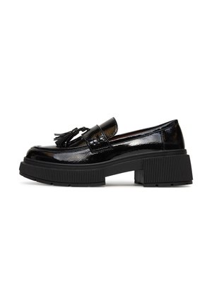 Black patent leather loafer with chunky ridged platform sole and tassel detail on front, side view on white background.