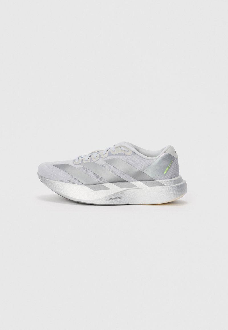 Light gray running shoe with a mesh upper, three darker gray stripes, and a textured sole. Features a padded collar and logo accent in green.