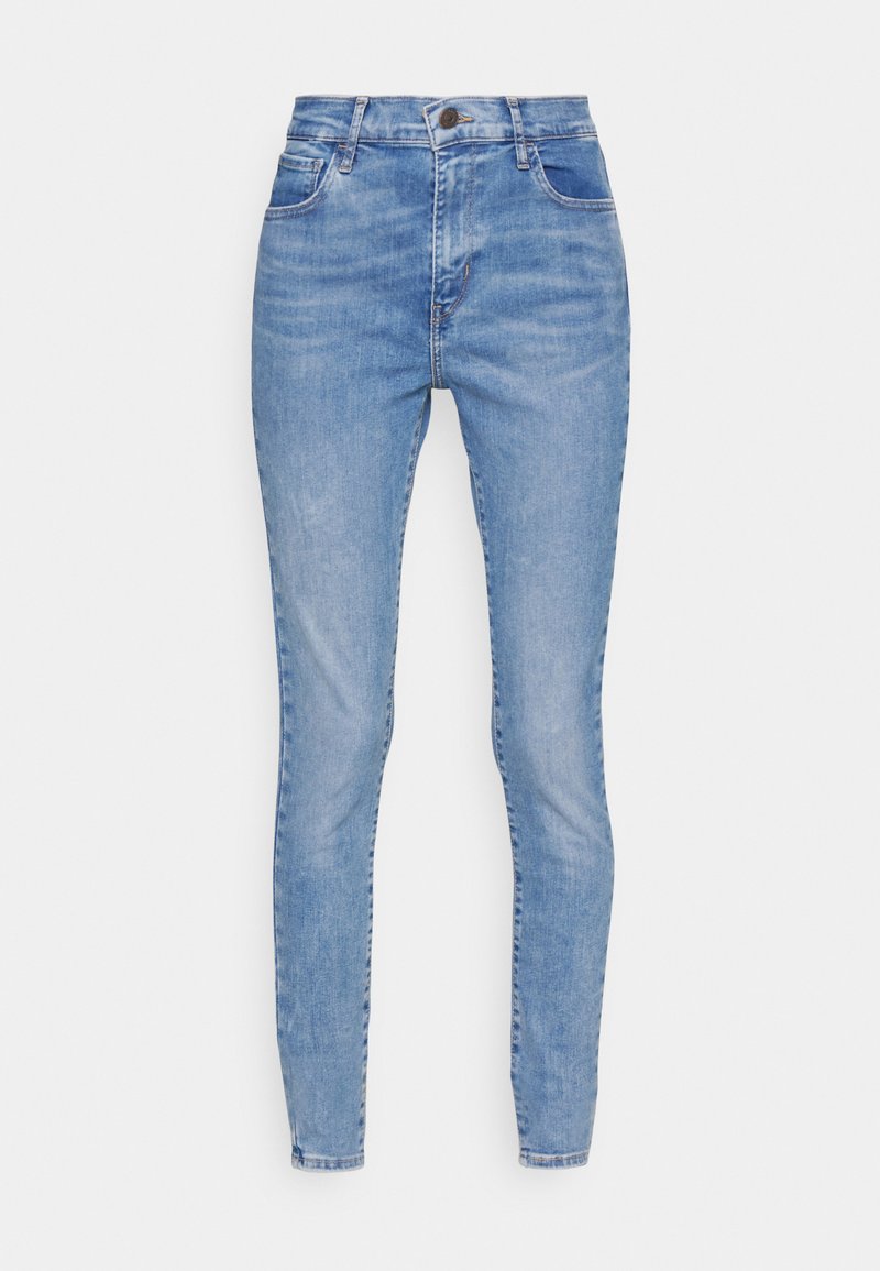 Hellblaue Skinny-Jeans mit klassischem Fünf-Taschen-Design, ausgestattet mit einem Knopf- und Reißverschluss, aus einem Denim-Stoff mit leichter Ausbleichung.