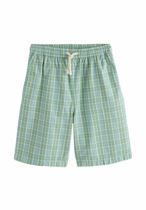 Vihreät ja siniset ruutukuvioiset joustavat shortsit, joissa on valkoinen naru rusetilla sidottuna valkoisella taustalla.