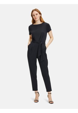 Black jumpsuit with short sleeves and a round neckline. Features a belted waist and side pockets, tailored fit with tapered legs.