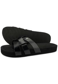 Black slide sandals featuring a smooth leather upper with woven straps, a cushioned footbed, and a textured rubber sole.