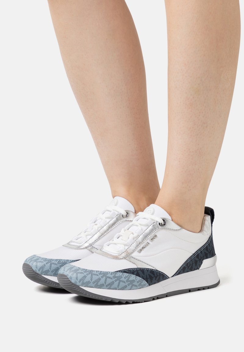 White and blue sneakers featuring a mixed material design with mesh and patterned accents, lace-up closure, and a textured sole.