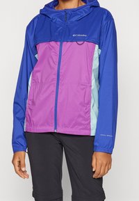 Lightweight, multi-colored jacket featuring a navy blue upper, purple middle section, and teal accents. Full zipper and adjustable hood.