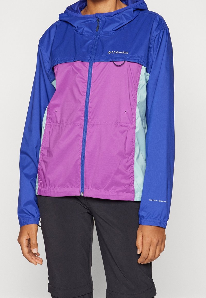 Lightweight, multi-colored jacket featuring a navy blue upper, purple middle section, and teal accents. Full zipper and adjustable hood.