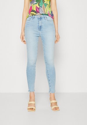 Blugi skinny de culoare albastru deschis, din denim, cu un finisaj decolorat. Cusături detaliate pe margini și un design clasic cu cinci buzunare.