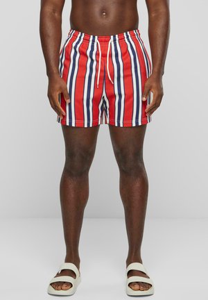 Red and white striped swim shorts with navy accents, featuring an elastic waistband and drawstring. The design is lightweight and quick-drying.