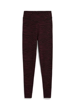 Hooggesneden leggings in een donker bordeauxrood met een subtiel zebrapatroon, gemaakt van rekbare stof voor comfort. Zachte textuur door het geheel.