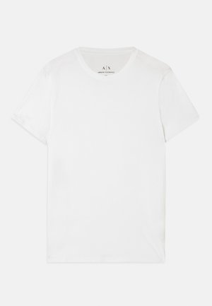 Bela bomba majica iz bombaža s klasičnim okroglim ovratnikom in kratkimi rokavi. Ima subtilno oznako blagovne znamke znotraj ovratnika, brez dodatnih vzorcev.