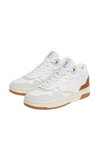 White sneakers with suede accents, rubber soles, and mesh panels. Features laces, perforated sides, and brand logo on tongue.