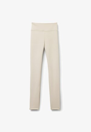 Leggings beiges en tissu extensible. Taille haute, forme ajustée, avec une texture lisse et sans motifs ni accessoires visibles.