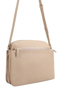 Beige leren schoudertas met een verstelbare riem, een voorvak met rits en een oppervlak met steentextuur.