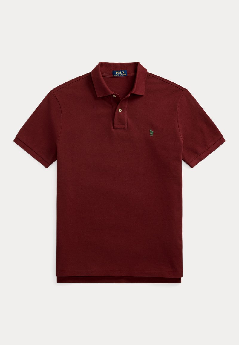 Burgundi värvi polo särk, mis on valmistatud puuvillast, koos klassikalise kaelusega, kahe nööbiga, lühikeste varrukatega ning vasakul rinnal rohelise logoga.