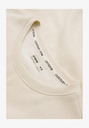 Katoenen crewneck sweatshirt in lichtbeige, met een geribbelde halslijn en een binnenlabel met de merknaam "ombre" en maatinformatie.