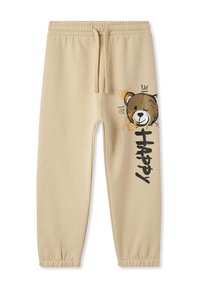 Beżowe dresy z elastycznym paskiem w talii i ściągaczami przy kostkach. Na lewym nogawce nadruk z graficznym wizerunkiem misia oraz napisem "Happy" i abstrakcyjnymi akcentami.
