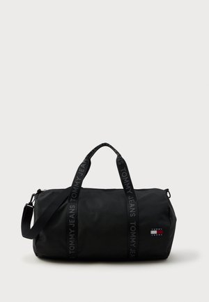 Borsa duffel nera realizzata in materiale liscio, con doppie maniglie e una tracolla rimovibile. Accento del logo e chiusura a zip.