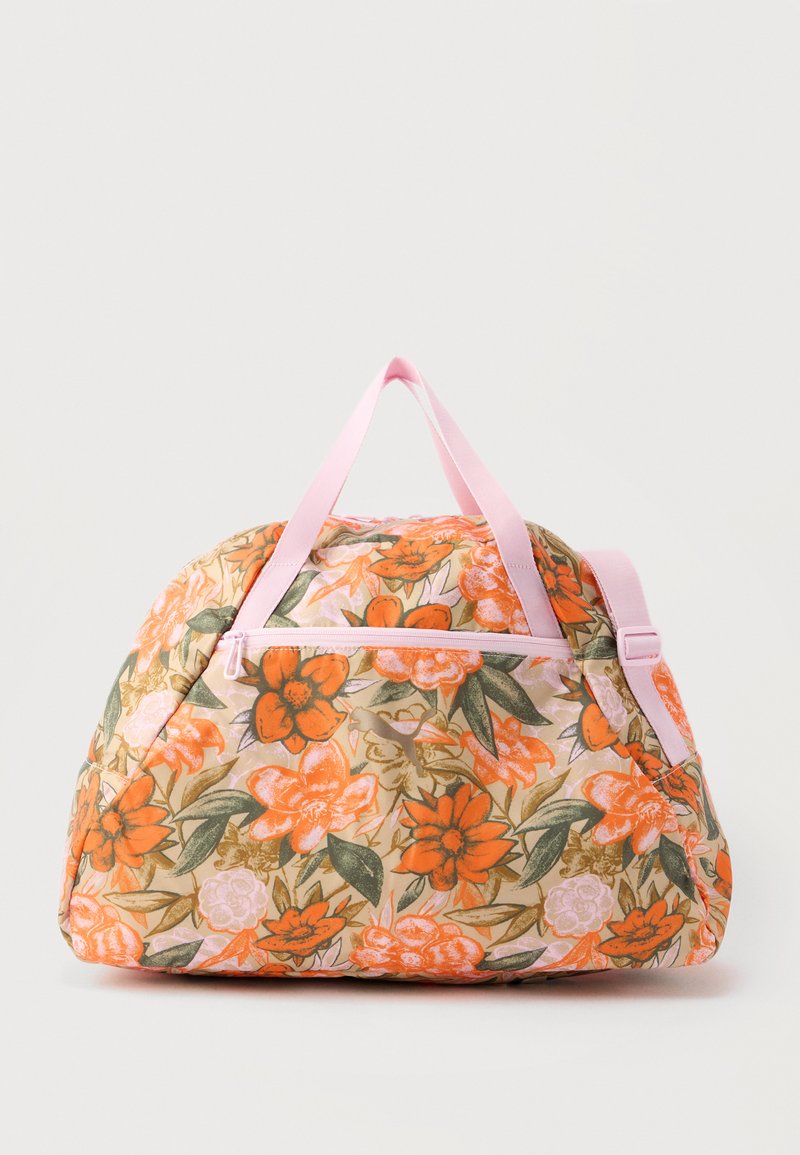 Reisetasche mit Blumenmuster in Orange und Pink, grünen Blättern, pinkfarbenen Griffen und einer Reißverschlusstasche vorne vor hellem Hintergrund.