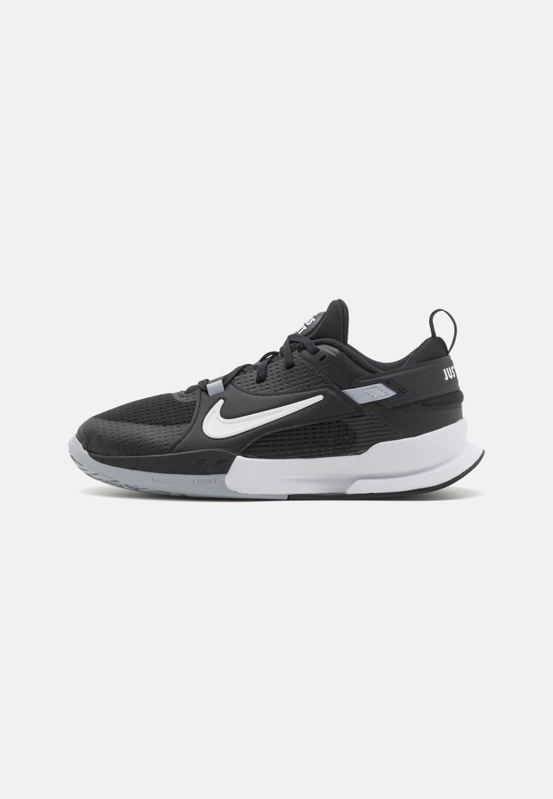 Čierne športové topánky s textúrovaným zvrškom, biely Nike Swoosh, sivé akcenty, polstrovaný golier a výrazná gumová podrážka.