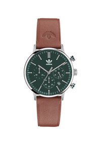 Roheline lõuendi kell koos hõbedaste detailidega, pruun nahkrihm, kronograafi funktsioonid ja kuupäeva näidik umbes kella 4 juures.