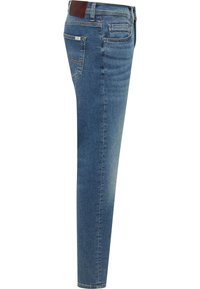 Schmale Jeans aus blauem Denim mit fünf Taschen, einer mittelhohen Taille und dezenten Steppnähten. Ein braunes Kunstlederpatch auf der Rückseite.