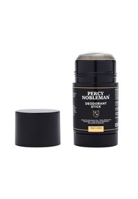 Déodorant en bâton noir avec un design à rotation, doté d'un capuchon en plastique transparent. L'étiquette comprend le nom de la marque et les détails du produit en texte doré et blanc.