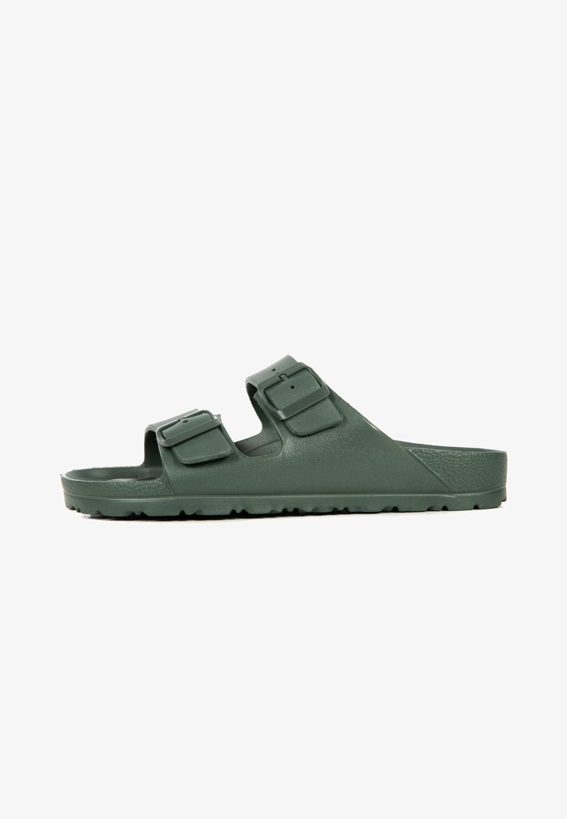 Sandale en caoutchouc vert avec deux sangles réglables, semelle texturée et semelle crantée pour une meilleure adhérence. Design minimaliste avec côtés ouverts.