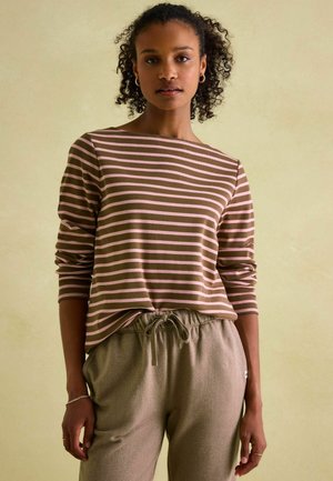 Brown and pink striped long-sleeve shirt with a relaxed fit, paired with light brown herringbone-patterned joggers featuring a drawstring waist.