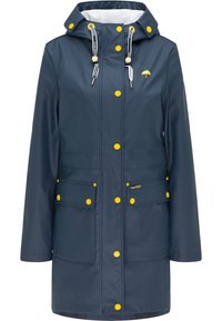 Marinblå vattentät regnjacka med gula detaljer, dragsko i huvudet och tryckknappar. Har två framfickor och en avslappnad passform.