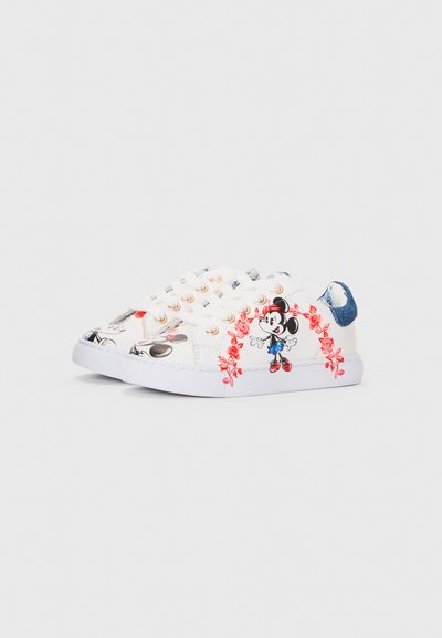 White sneakers with colorful Mickey Mouse graphics, floral accents, gold eyelets, and a denim heel tab. Rubber sole and lace-up design.