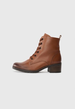 Brown leather ankle boot with rounded toe, lace-up front, and a small heel. Smooth texture and stitching detail on the side.