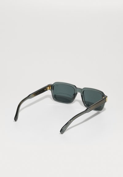 Square sunglasses with dark gray lenses and textured black plastic frame. Gold accents on the temples add contrast to the design.
