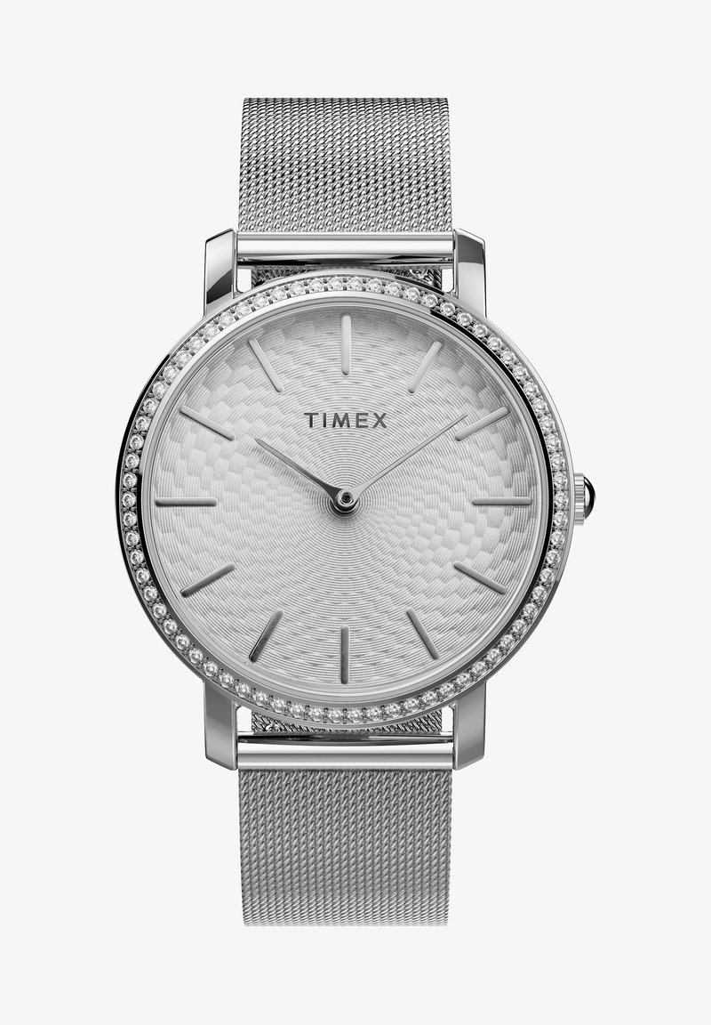 Timex ur med en sølv mesh-rem, en struktureret sølvskive og en bezel med krystalaccenter. Har minimalistiske timemarkører og visere.