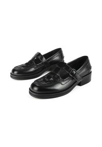 Black leather woven loafers with buckle straps and low block heels, displayed on a white background.